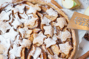 Traditional apple pie on the table with decorations.