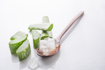 aloe vera gel on wooden spoon with aloe vera on white background,aloe vera is tropical green...