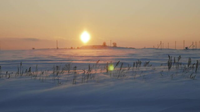 Arctic snow storm at sunset. Polar snow drifting storm and blizzard. Extreme Temperature.