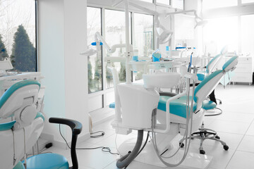 Interior of a modern dentist office with brand new dentist chairs - obrazy, fototapety, plakaty
