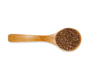 Top view  wooden spoon with buckwheat isolated on a white background. Kitchen utensil and cooking ingredients template.