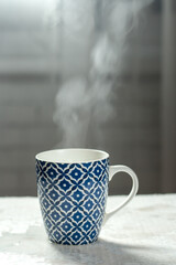 Obraz na płótnie Canvas Front view of a blue mug with steam. Water steam. 
