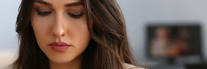 Close up of pretty young busy lady looking at smartphone screen while staying in the office