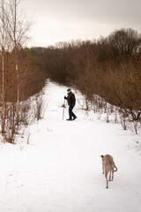 man walking his dog in winter