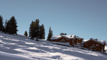 snow wandering in a village on the mountains on a beautiful sunny winter day