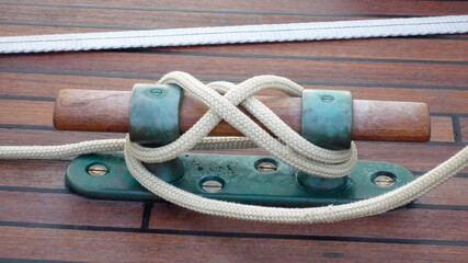 wooden and verdigris brass boat ship yacht rope cleat