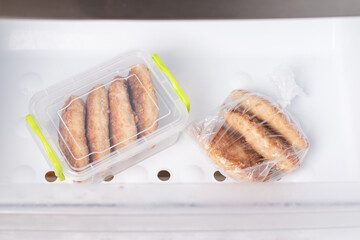 Frozen cutlets in a container in a refrigerator. Ready frozen food. Fast cooking concept.