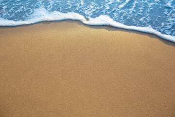 Fototapeta na wymiar Beautiful ocean waves on the sandy beach Abstract style nature background pastel tones