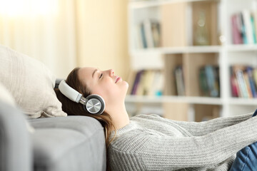 Relaxed teenager female listening to music at home
