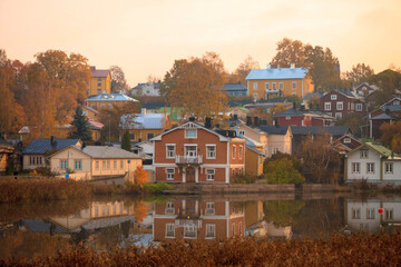 Fototapeta premium Beautiful panorama of the embankment rivers and urban architecture, colored houses, roofs and churches of the city of Porvoo in finland