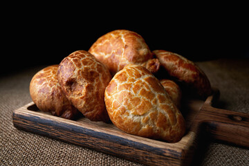 Homemade pies made from yeast dough, on a wooden board, on sacking