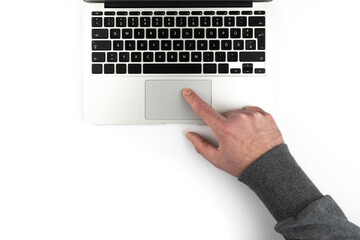 overhead view of person using touchpad or trackpad on laptop computer on white background - obrazy, fototapety, plakaty