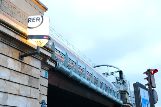 Paris, France. January 17. 2021. Suspended bridge with the passage of a RATP metro passing at full speed. RER logo in close-up. Ecological public transport.