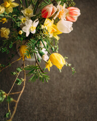 Flower composition on dark background. White, yellow, red tulips. Spring bouquet. Valentines day card.