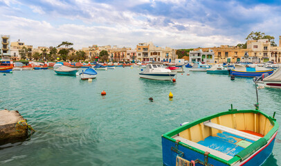 Fototapeta na wymiar Small fishing village with its typical boats, on the island of Malta