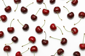 pattern ripe delicious cherries scattered in a chaotic order on a white background without people