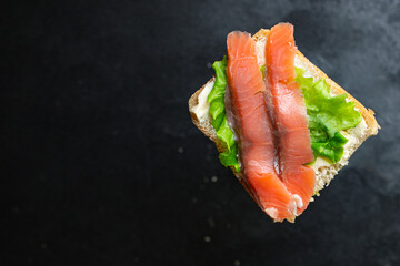 Smorrebrod sandwich salmon fish bruschetta with seafood antipasto aperitif on the table for healthy meal snack outdoor top view copy space for text food background 