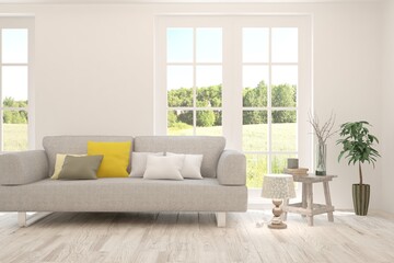 White living room with sofa and summer landscape in window. Scandinavian interior design. 3D illustration
