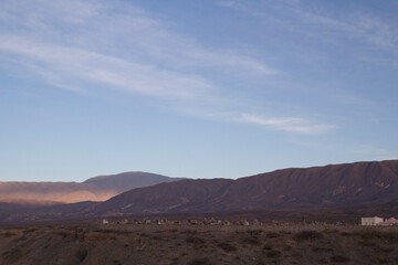 The beautiful arid mountains and desert at sunset. View of an ancient cemetery very high in the mountaintop in Cachi, Salta, Argentina.