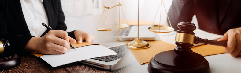 Business and lawyers discussing contract papers with brass scale on desk in office. Law, legal...