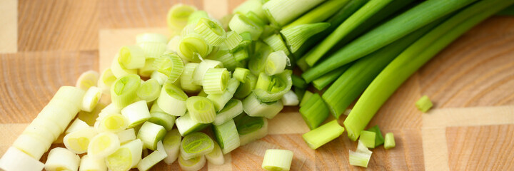 Top view of sliced fresh green onions on a cutting board for making salad. Cooking recipes concept