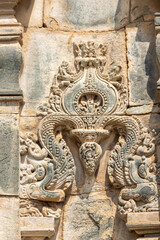 Lakkundi, Karnataka, India - November 6, 2013: Kasivisvesvara Temple. Non-figurative beige stone decorative fresco on outside wall.