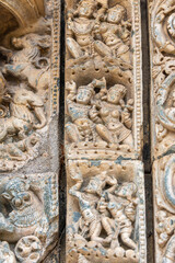 Lakkundi, Karnataka, India - November 6, 2013: Kasivisvesvara Temple. Detail of beige stone detailed sculptures on multi-frame around entrance.