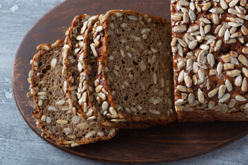 Sliced rye bread on cutting board. Whole grain rye bread with seeds