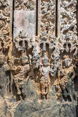 Lakkundi, Karnataka, India - November 6, 2013: Kasivisvesvara Temple. Damaged row of dwarapalakas as plinth at bottom of entrance frame. 