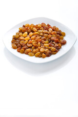 Dried sweet golden raisins on isolate on white background copy space.
