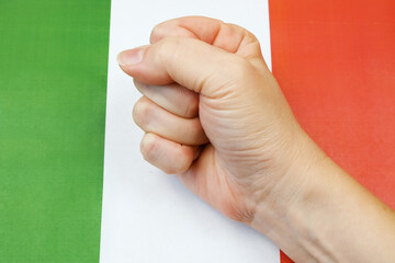 clenched fist against the background of the Italian flag, protests in Italy