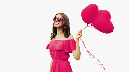 Portrait of happy smiling woman with pink heart shaped balloon on a white background