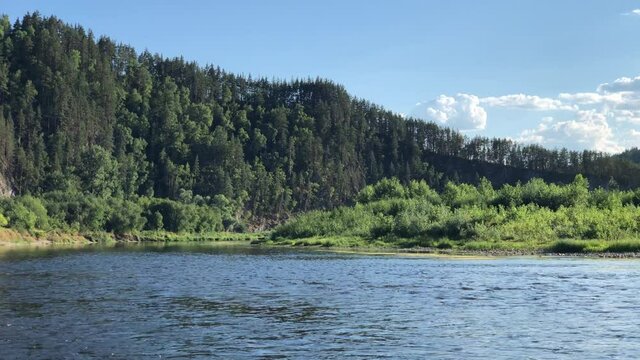 Strunning view of calm water of Agidel river in summer during rafting