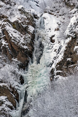 Obraz na płótnie Canvas beautiful frozen waterfalls with fresh snow on a cold winter day