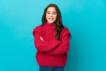 Obraz premium Little caucasian girl isolated on blue background keeping the arms crossed in frontal position