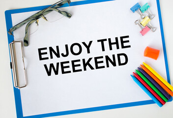 A clipboard with text Enjoy The Weekend