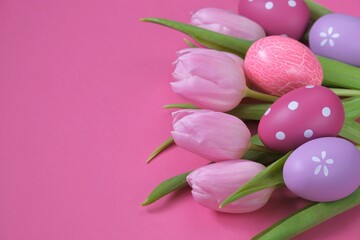 Easter holiday.pink tulips flowers, purple and pink easter eggs set  on fuchsia
background.Easter...