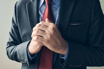 Anxious businessman wringing hands