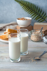 Two glasses of milk on a gray background with food. Side view with copy space. The concept of useful products.