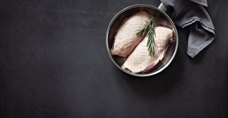 Uncooked duck breast with herbs and spices. Flat layot, copy space