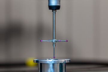CMM - Coordinate Measuring Machine - contact probe measure aluminium sample part on glass table...