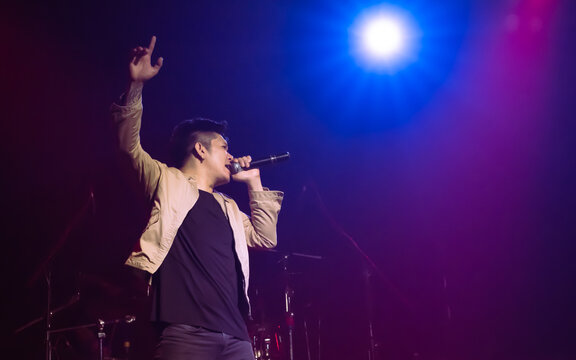 Asian Male Singer Showing His Performance On Stage