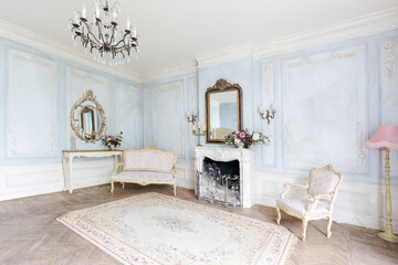 cozy living room interior with chic beautiful antique baroque furniture, walls are decorated with stucco and wooden parquet. daytime warm soft light.