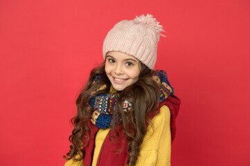 cheerful child girl with long hair and warm clothing, smiling beauty