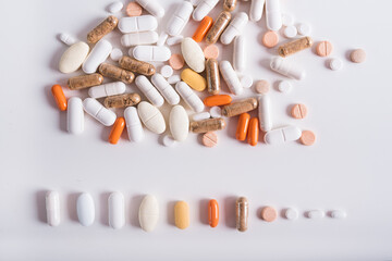  Different kind of pills and capsules on white background. Pharmaceutical packaging with drugs and pills. Concept of medicine. 