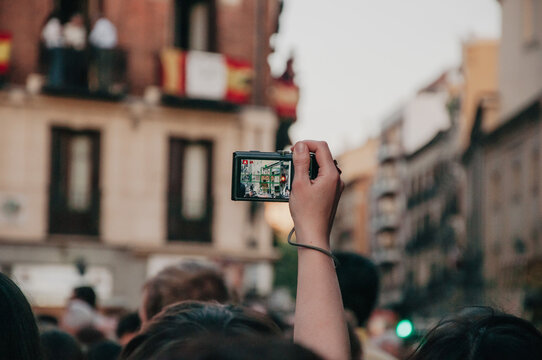 Person taking a picture in a crowd