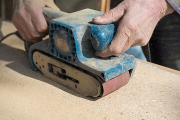 Person With Looped Belt Sanders - Closeup