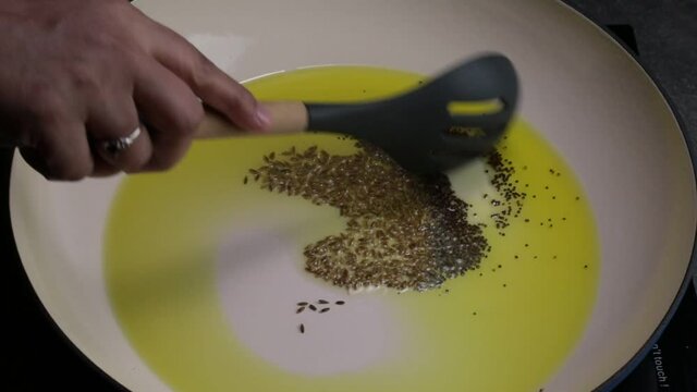 Frying peanuts with Cumin seeds and Mustard seeds