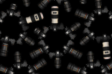 Mirrorless Cameras with different lenses for shooting videos. Top view of digital cameras isolated on black background. Photography pattern design.