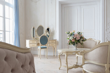 luxurious light interior in the Baroque style. A spacious room with a road chic beautiful...